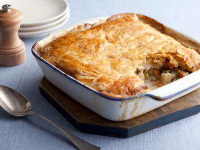 A photo of a vegetable pot pie on a cutting board.