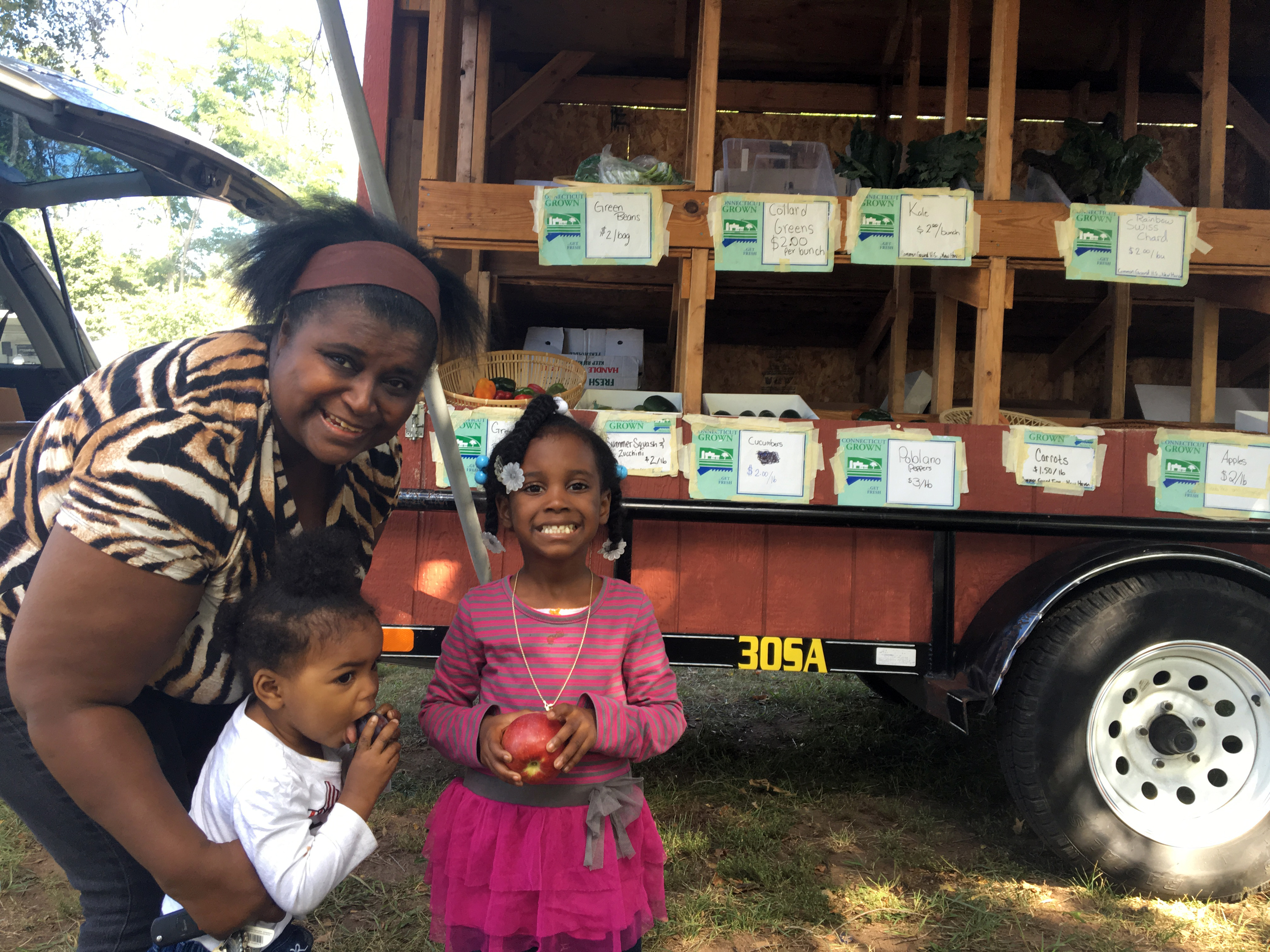 A family purchases fruit and vegetables at the CitySeed and Common Ground Mobile Market.